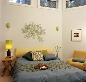 The classic 1950s designs of the vintage chair and table blend well with the bedroom's new eco-friendly and recycled-fiber décor.